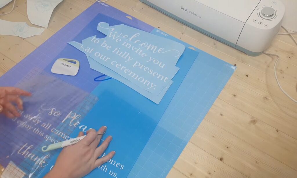 image of me putting the vinyl on the acrylic sign